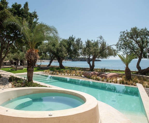 The Echo Of The Sea Beachfront Villa pool in between the trees and sea view