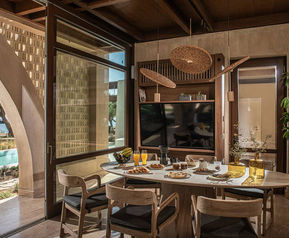 The Echo Of The Sea Beachfront Villa decorated dining table and amenities