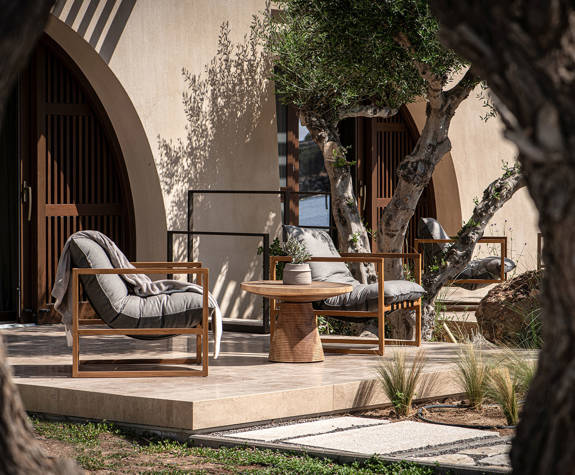 The Echo Of The Sea Beachfront Villa terrace with two chairs and a decorated small round table