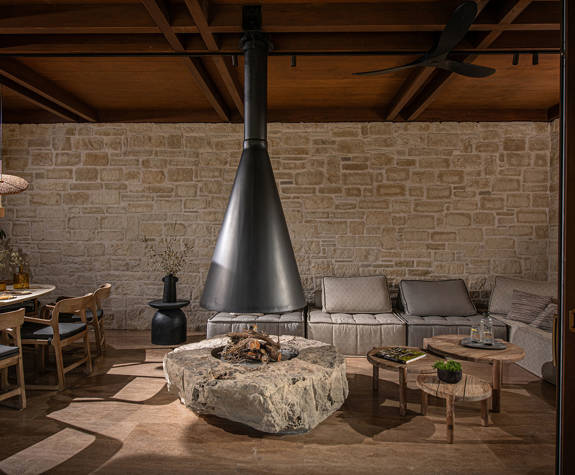 The Echo Of The Sea Beachfront Villa dining area with fireplace and a big sofa