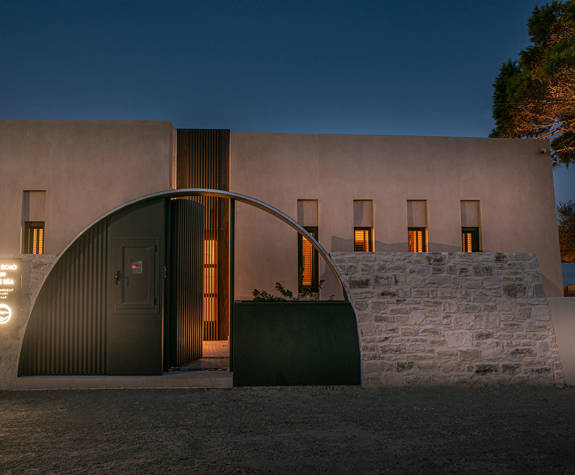 The Echo Of The Sea Beachfront Villa exterior entrance lit up at dusk