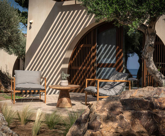 The Echo Of The Sea Beachfront Villa terrace with two chairs and a decorated small round table