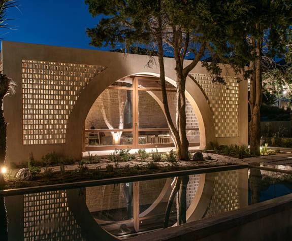 The Echo Of The Sea Beachfront Villa garden lit up at dusk