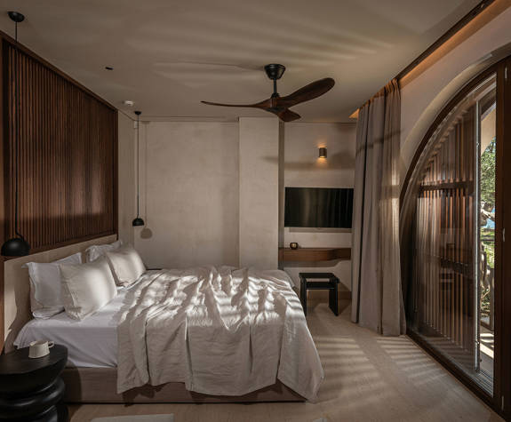 The Echo Of The Sea Beachfront Villa bedroom with double bed, amenities and terrace view